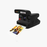 Polaroid Flip instant camera in use at Dubai event developing colour photo in hand UAE